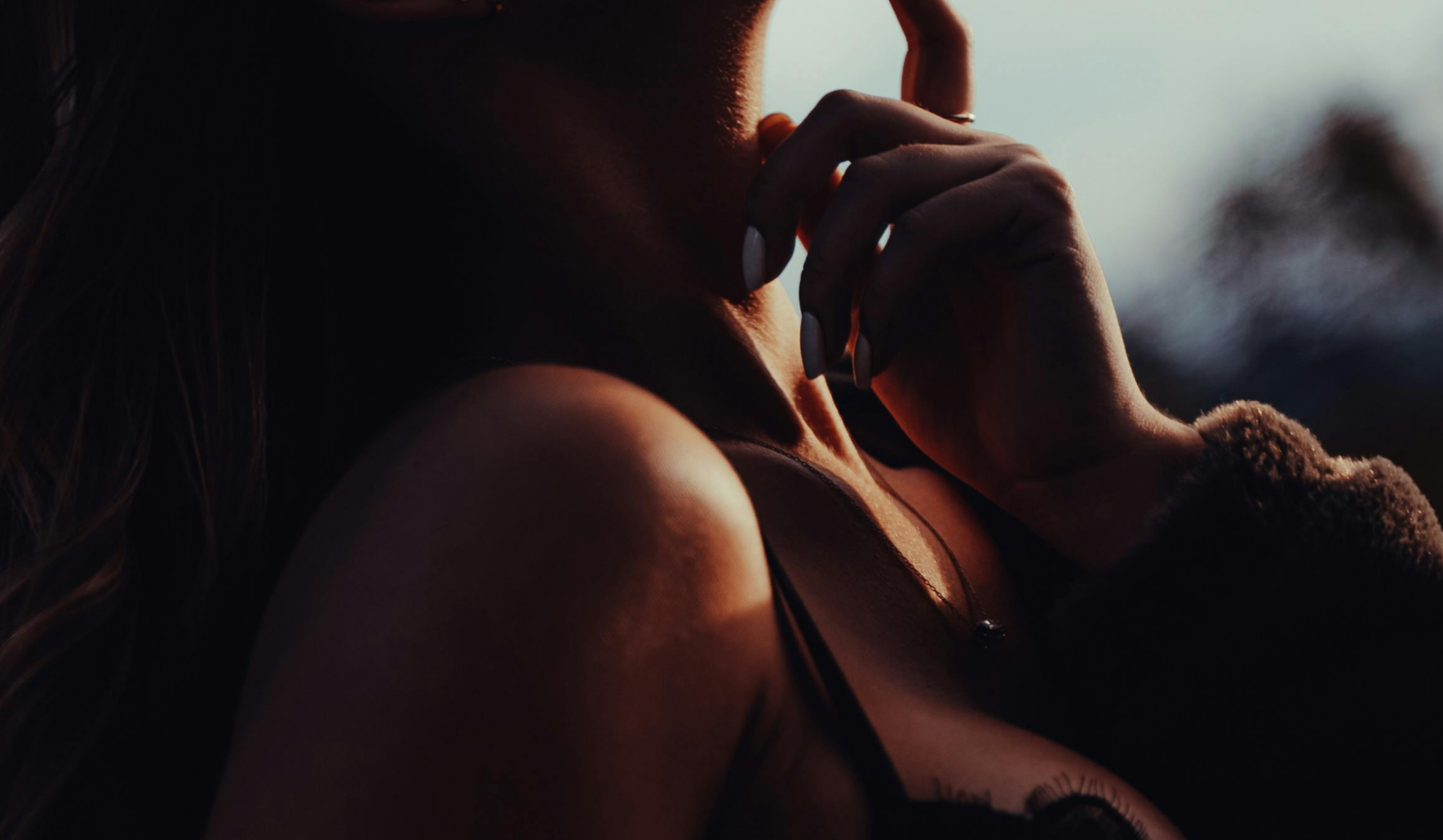 Woman resting in warm light, embodying nervous system healing and women’s pleasure.